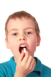 Shutterstock Boy swallowing pill 10556911